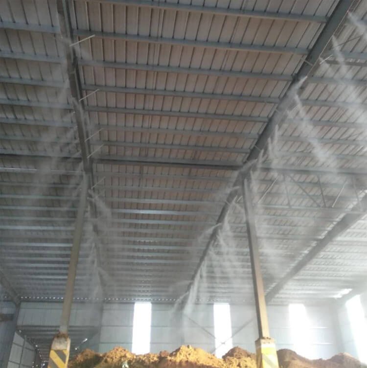 Ultrasonic atomizing nozzle for dry fog dust suppression at crushers and conveyors